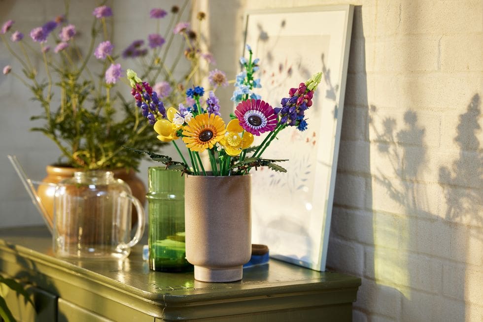 nice vase displaying LEGO flowers on a side table